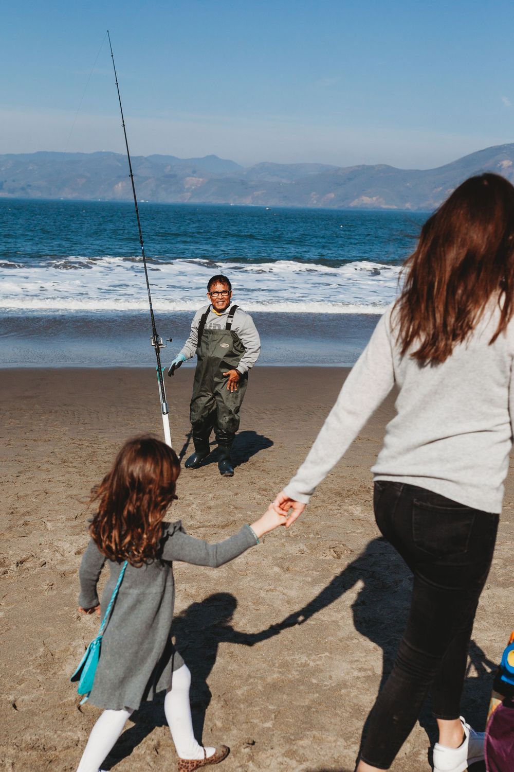 Father and daughter walking on China Beach San Francisco, family photography session at noon