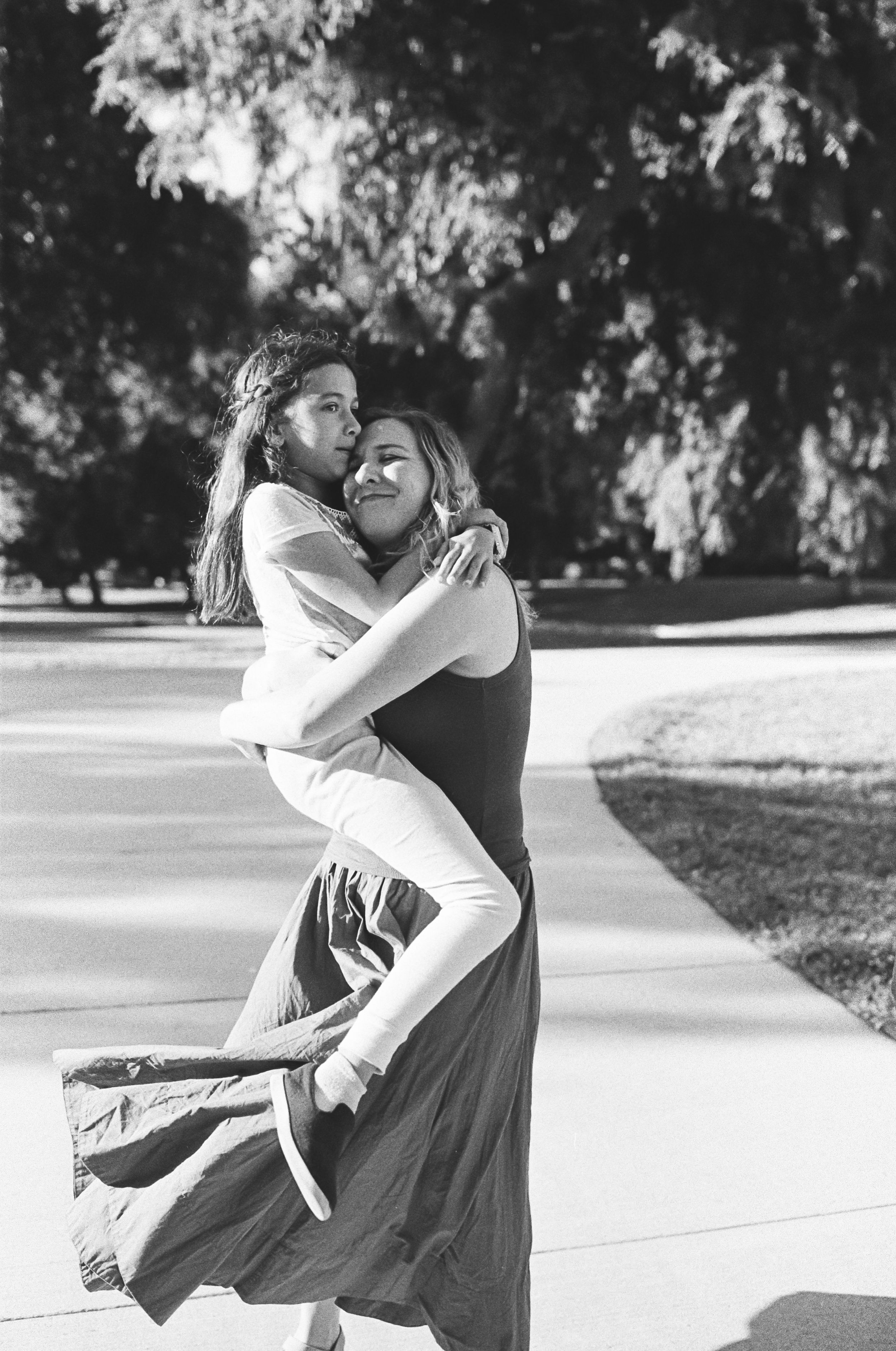 Black and white photo of a couple dancing playfully — lifestyle family photography