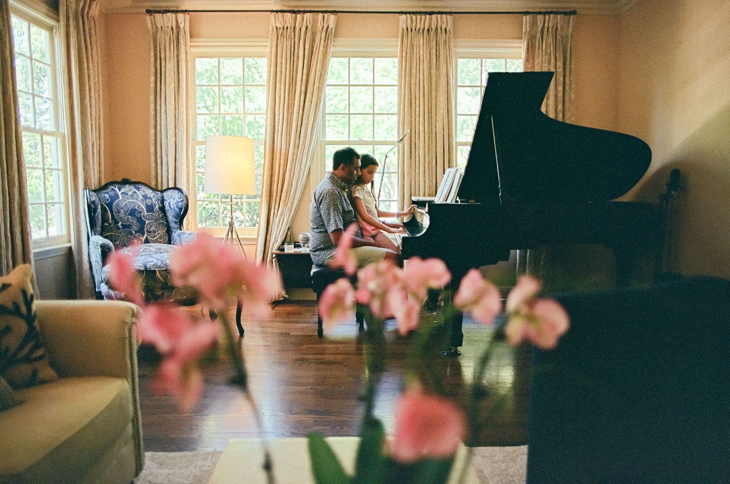 Father and child playing together at a grand piano during an in-home family session in Marin County