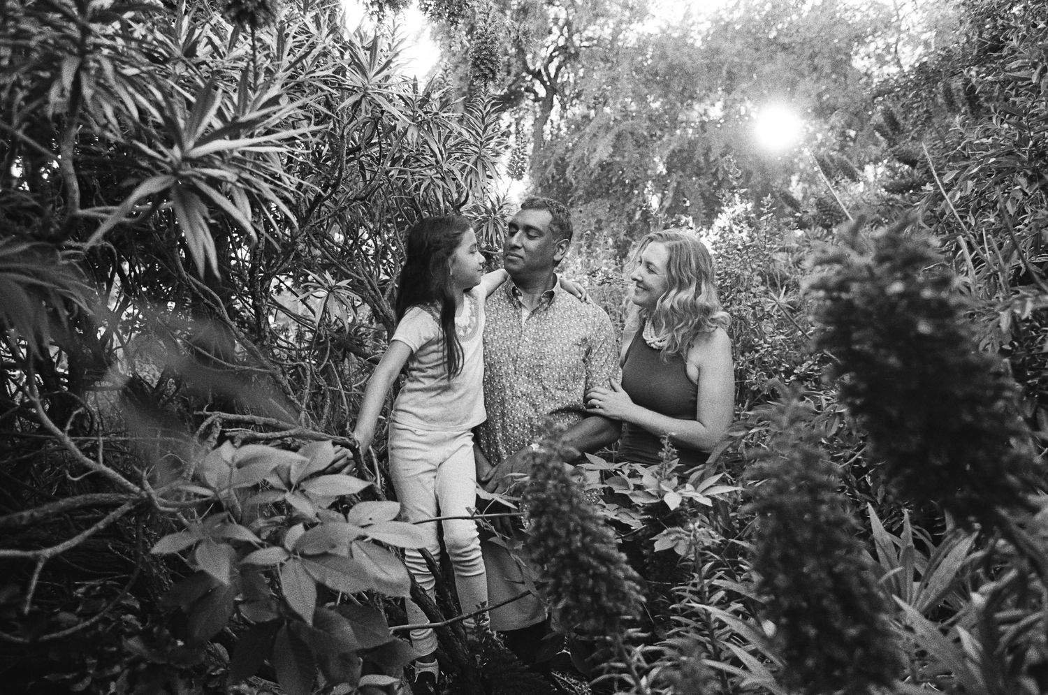 Family walking together in a lush garden — family mini sessions in Marin County