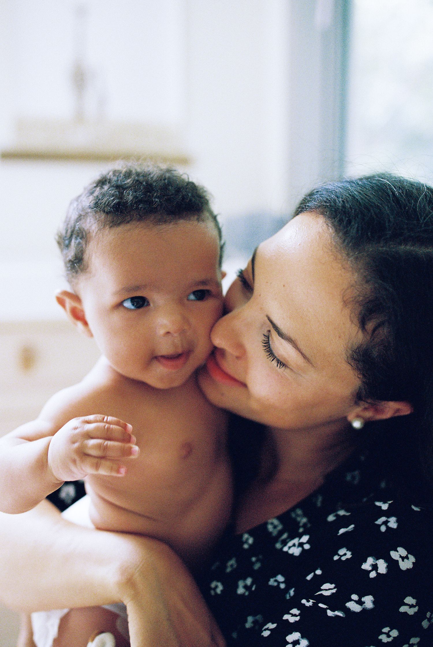 Sweet moments of affection between family members in bright, minimal light