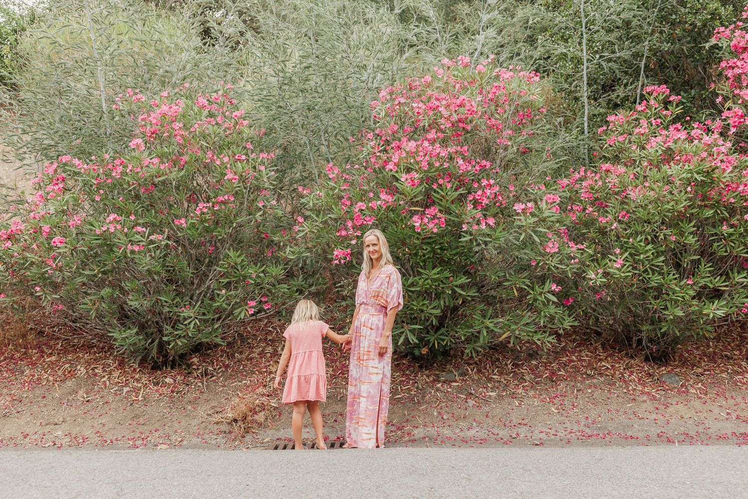 Mom and daughter standing in front of greenery and flowers during a San Anselmo mini session
