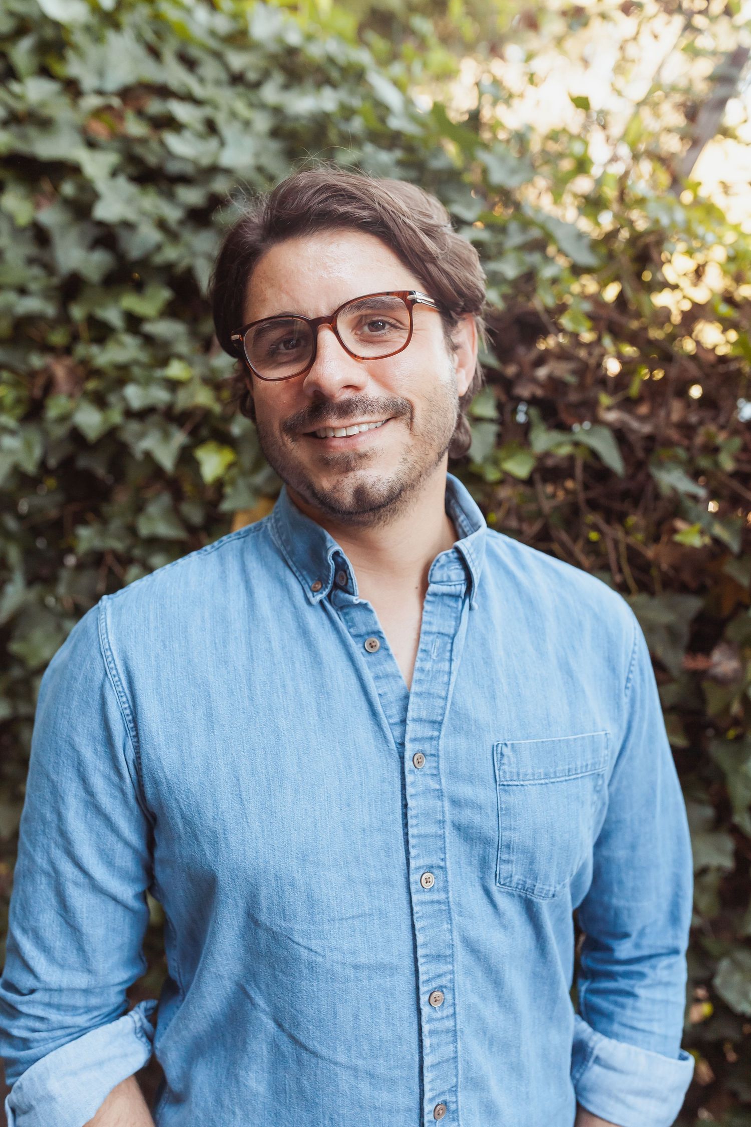 Casual outdoor headshot in a denim shirt and glasses — natural portrait in Marin County