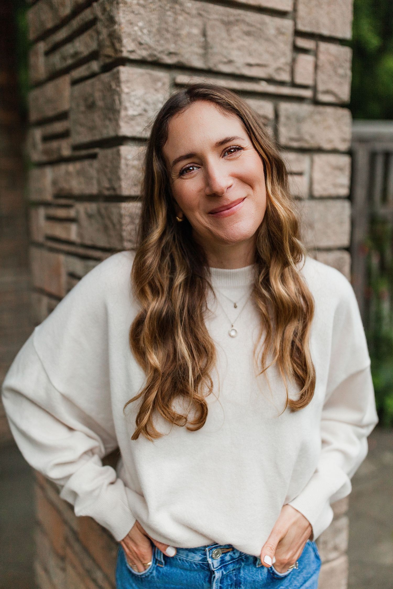 Lifestyle headshot portraits against a stone wall backdrop — on-location portrait photography
