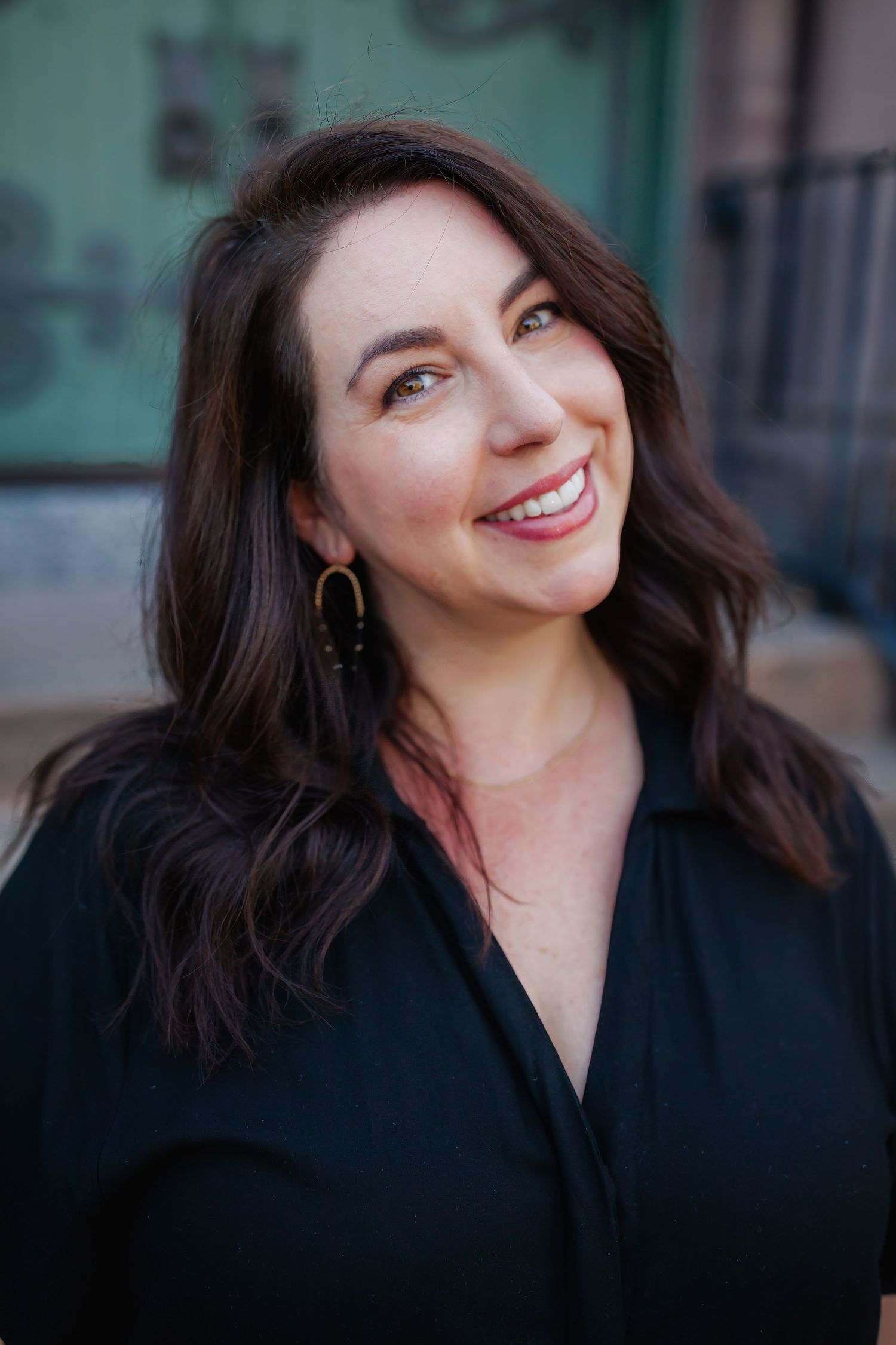 Professional headshot against a dark background — clean and polished portrait