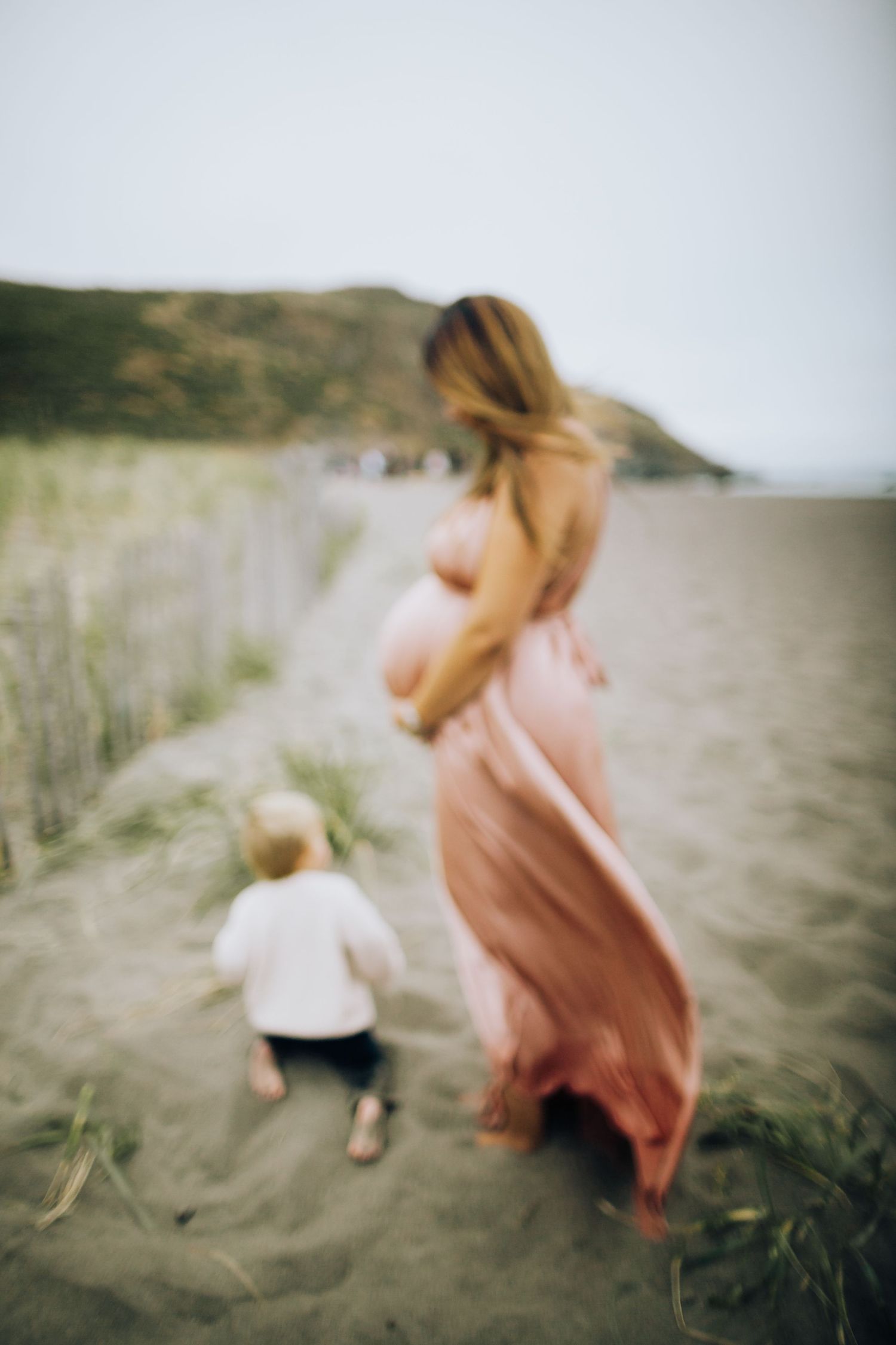 Flowing dress catches the coastal breeze — maternity session at the coast in Marin County