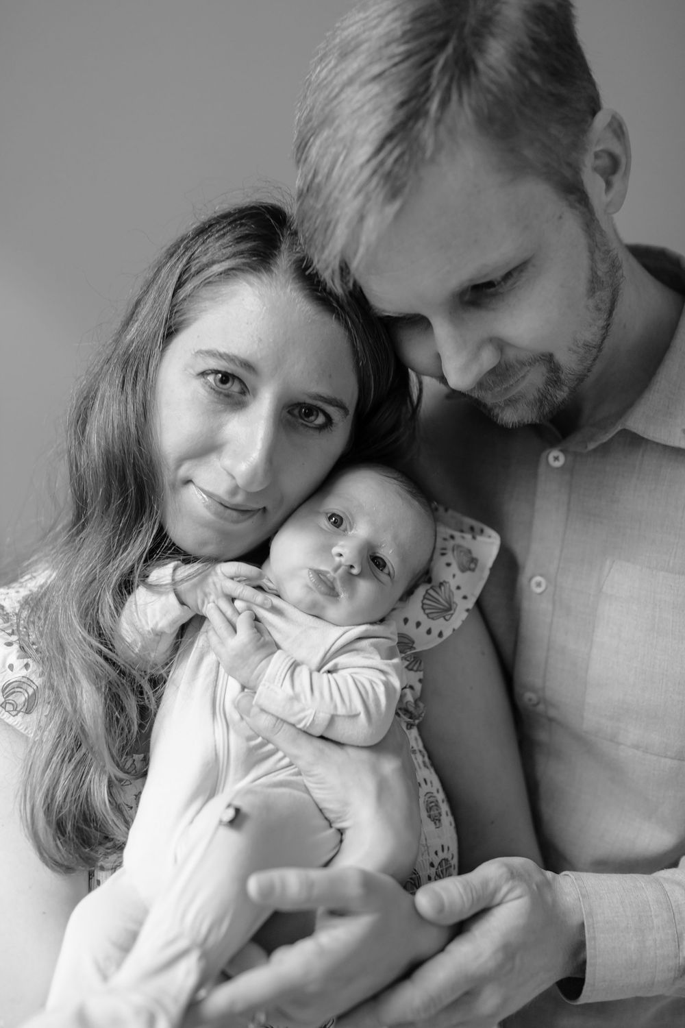 Black and white portrait of parents and newborn baby close together — San Anselmo Newborn Photographer