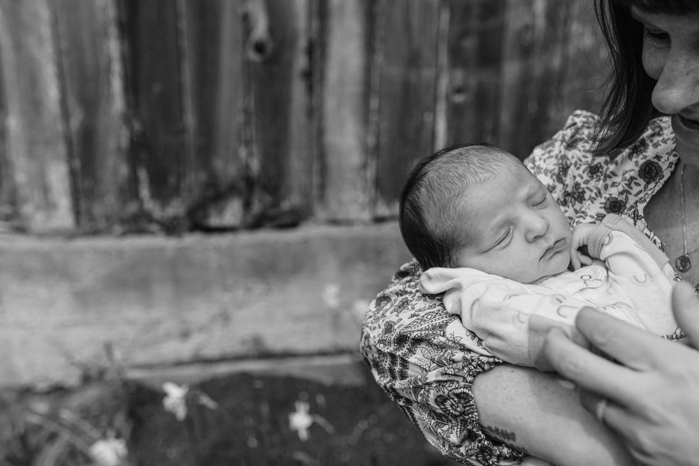 Black and white photo of a mother cradling her newborn