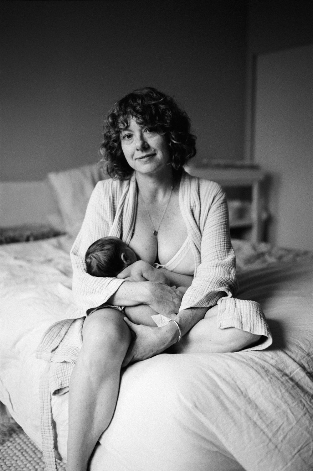 Intimate black and white newborn photography on a bed — San Anselmo Newborn Photographer