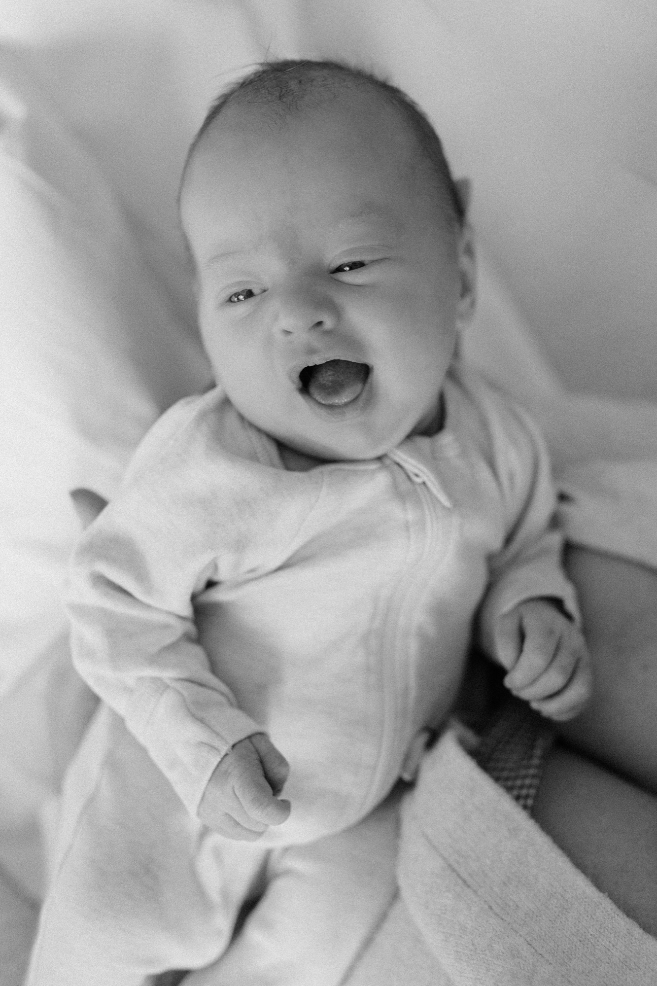 Baby Gwen mid-yawn, tiny fists open