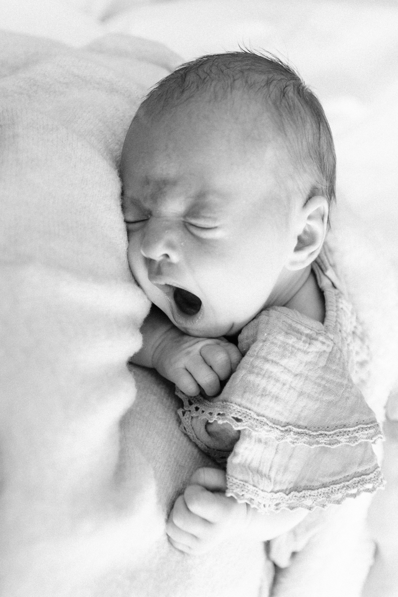 Mother holding her newborn during an in-home lifestyle session in Marin County